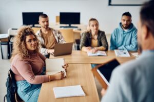 A group of social science degree students sitting at a table in a classroom.